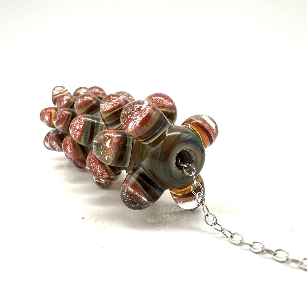 End view of blossom bead showing the layers in the dots and how the dots are stacked along the length of the bead. Dots are arranges so one round sits into the spaces left by the previous round.