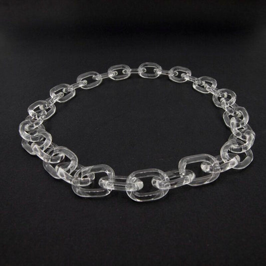 clear glass necklace made with bold links, photographed on dark background