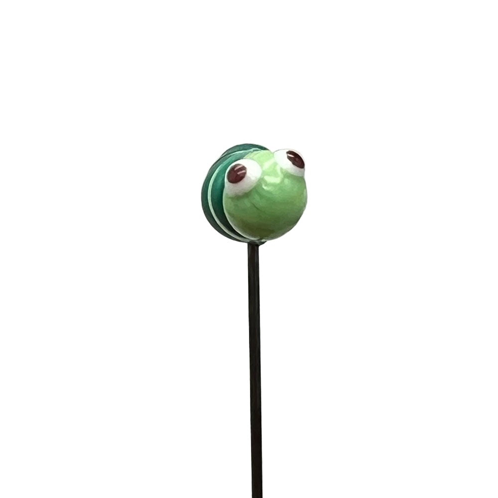 Front view of a handcrafted lampwork glass caterpillar pin, showcasing its charming face with red eyes and a striped green body.