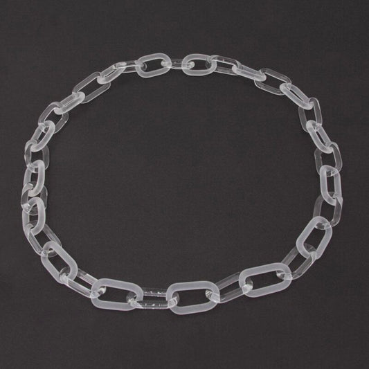 Necklace made from alternating links of clear and frosted glass, dark background