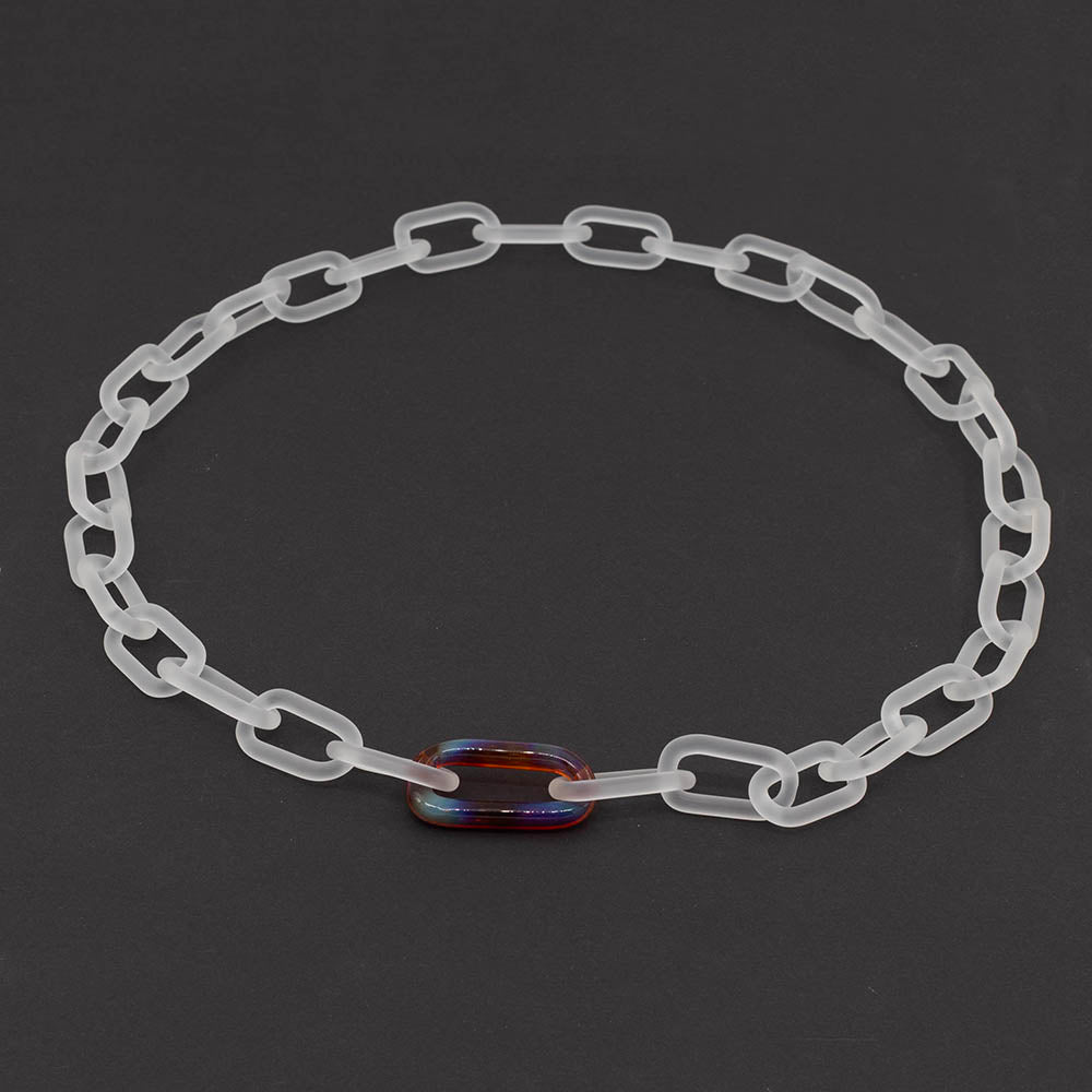 Frosted clear glass chain necklace with singe multicolour mai tai link on a dark background