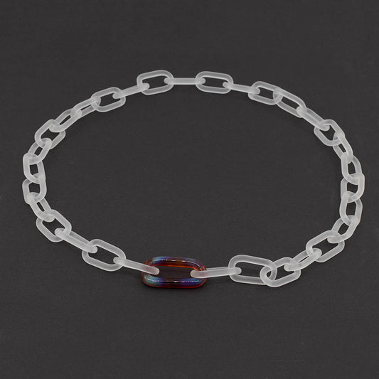 Frosted clear glass chain necklace with singe multicolour mai tai link on a dark background