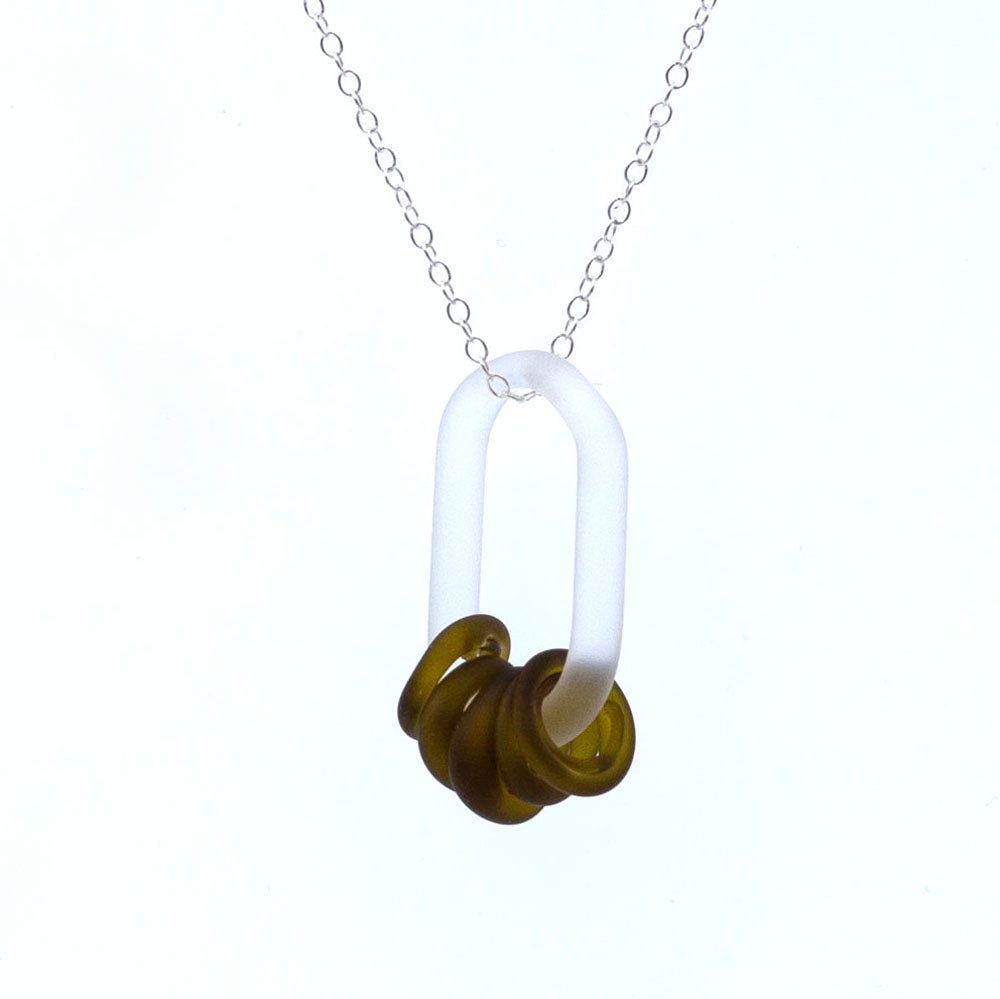 Close up of a frosted link made from clear glass which passes through five beads. The beads are made from a marmite bottle so are brown. They also have a frosted finish. The link hangs from a sterling silver chain.