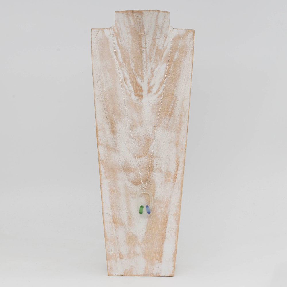 wooden bust with whitewashed finish displaying a frosted link necklace with green, white and blue beads