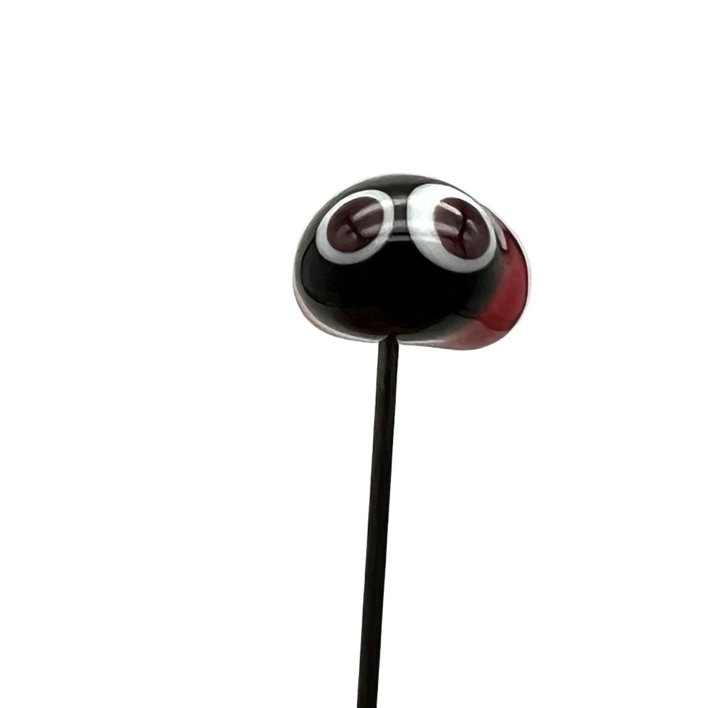 Handmade glass ladybird pin with a red body, black head, and large white eyes, front view, on a stainless steel