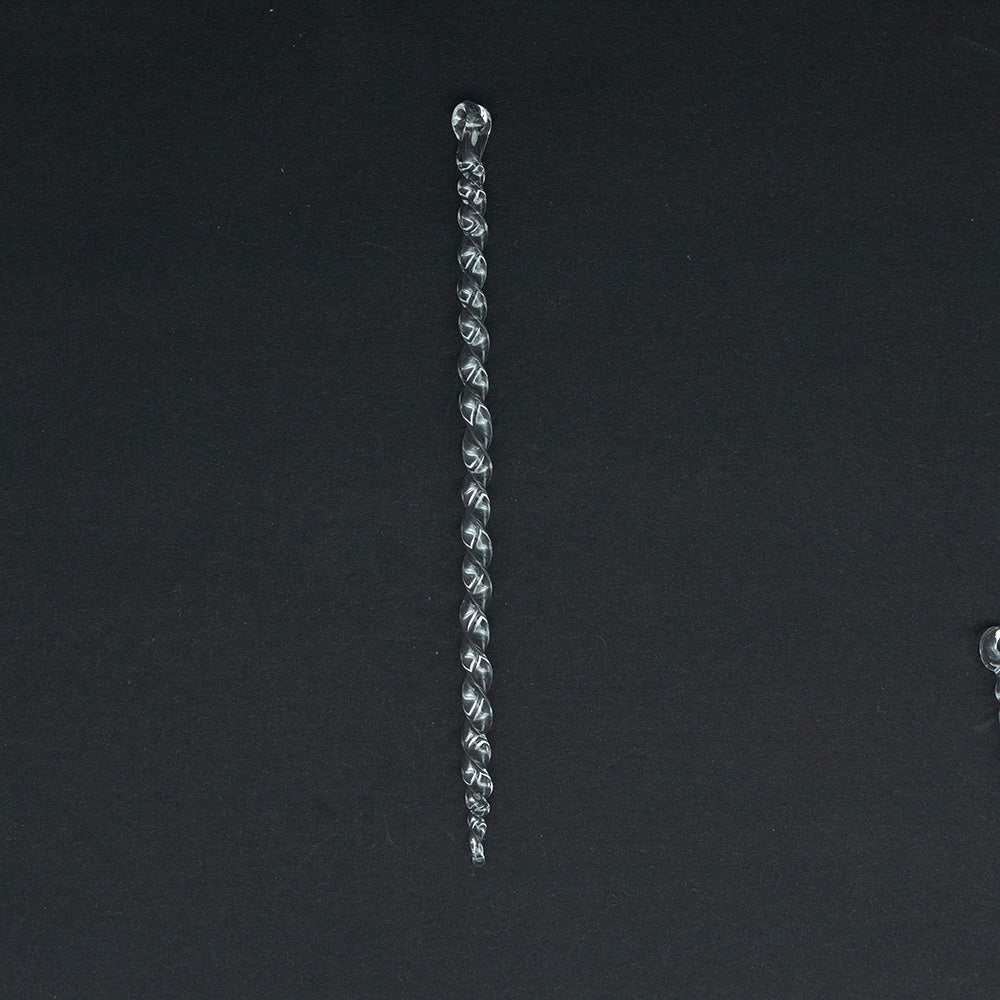 A large clear glass icicle made from thin glass rod with twists along its lebgth and a hanging loop.