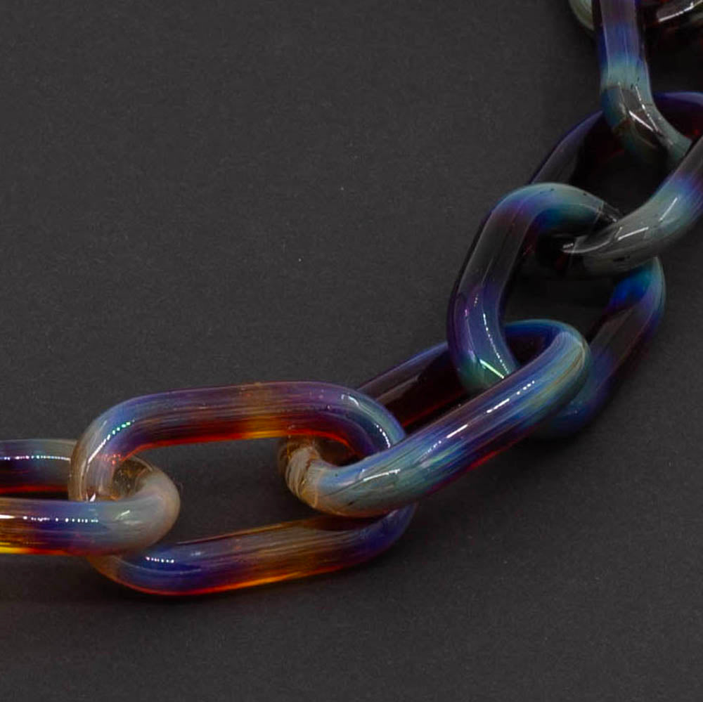 Close up of Mai Tai glass link necklace photographed on a dark background.