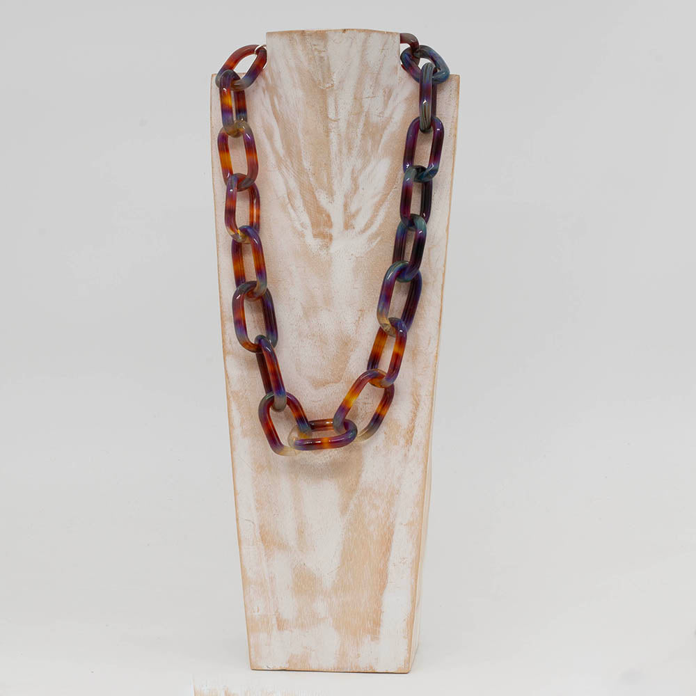 Close up view of whitewashed wood torso displaying a necklace made from multicolour mai tai glass links