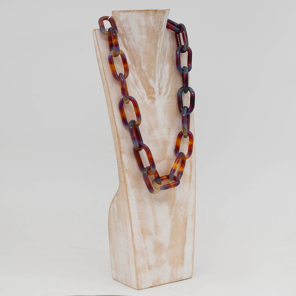 Side view of whitewashed wood torso displaying a necklace made from multicolour mai tai glass links