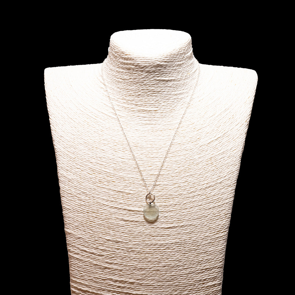 pale blue frosted glass shell imprint charm necklace with sterling silver chain shown on a white mannequin bust