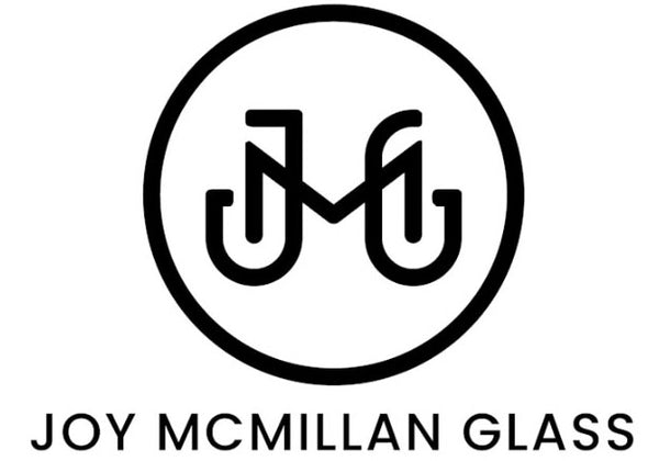 Our logo - intertwined letters J M and G in a circle with the text Joy McMillan Glass underneath