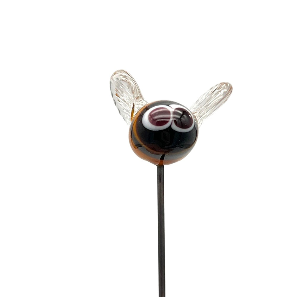 Front view of the handmade lampwork glass bee plant decoration, featuring the bee's black face with white eyes, and clear wings, against a plain background.
