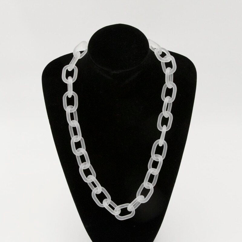 Black velvet bust showing frosted clear glass necklace made with bold links