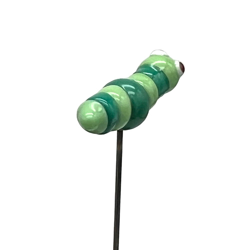 A glass caterpillar plant decoration on a stake, viewed from the back, showcasing its light and dark green striped body.