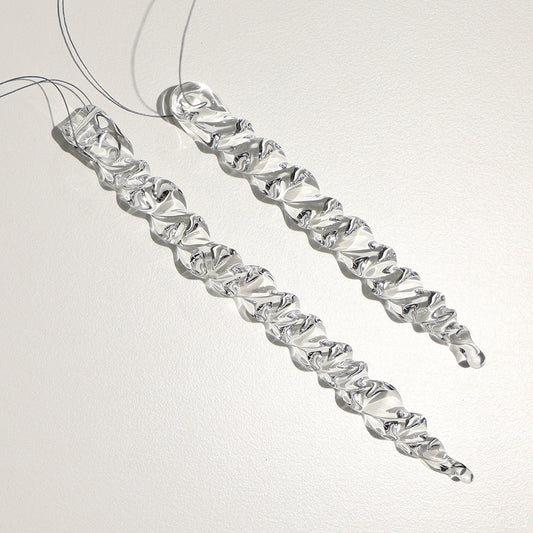 two chunky glass icicles with twistys along their lengths. Icicles are long and medium lengths.