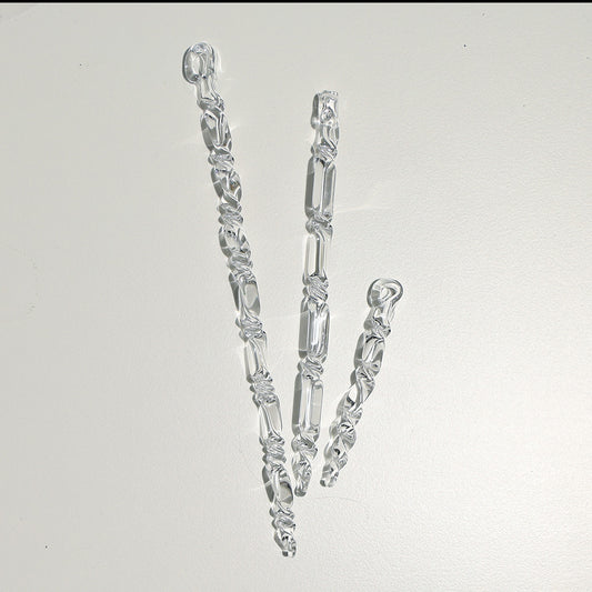 Three slim clear glass icicles of different lebgths. The iciles have twists along thier length.