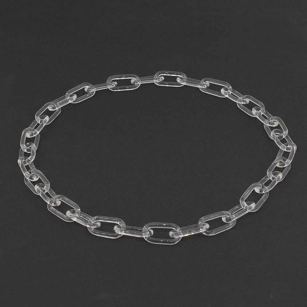 Clear glass chain link necklace photographed on a dark background