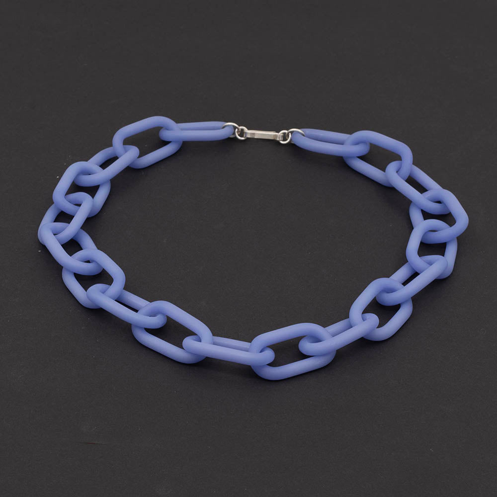 A necklace made from pale blue frosted glass links with silver hook and eye fastening, dark background