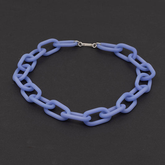 A necklace made from pale blue frosted glass links with silver hook and eye fastening, dark background