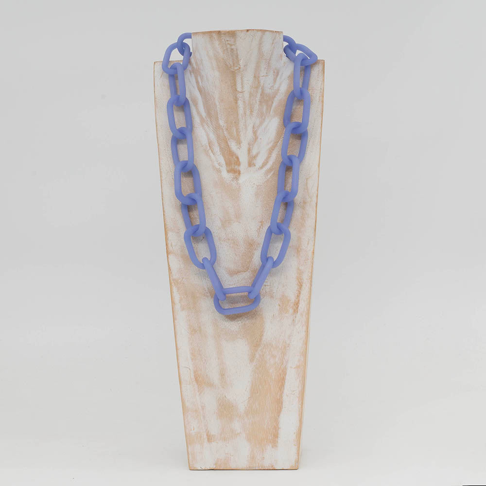 Front view of whitewashed wood torso displaying a necklace made from pale blue frosted glass links