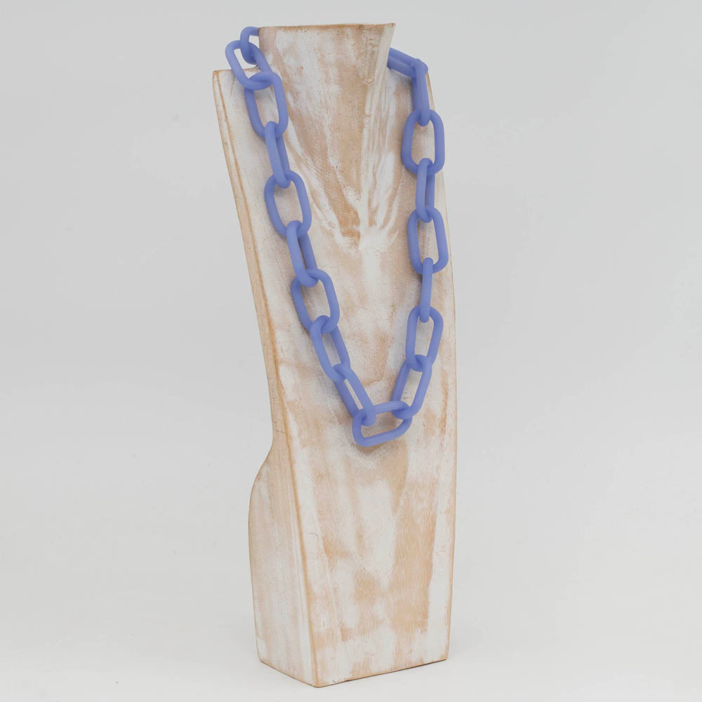 Side view of whitewashed wood torso displaying a necklace made from pale blue frosted glass links