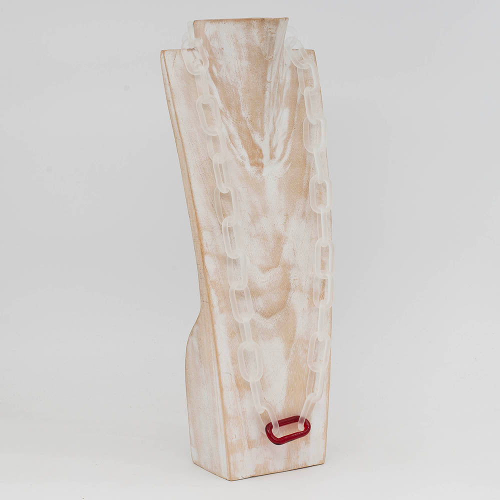 whitewashed wood torso displaying frosted clear glass link necklace with a single glass link