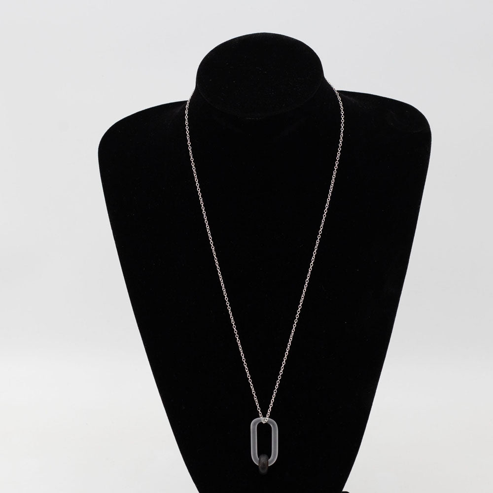 black velvet mannequin displaying a necklace with clear link and dark brown bead made from a recycled beer bottle