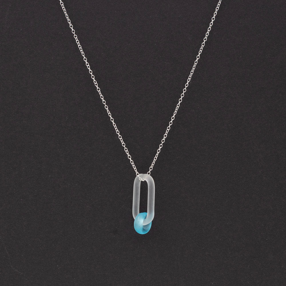 Necklace with link and Bombay Sapphire gin bottle bead on a dark background