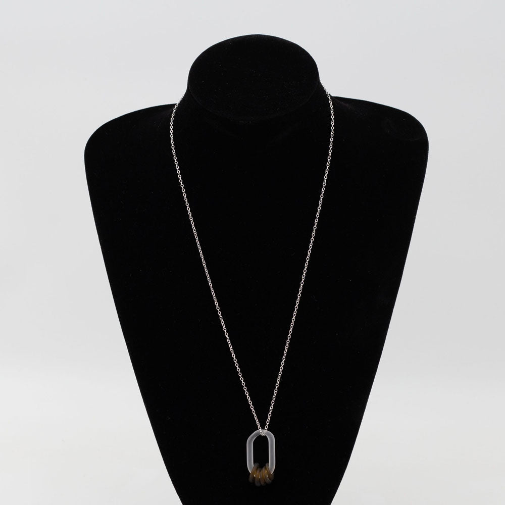 Black velvet mannequin displaying Close up of a frosted link made from clear glass which passes through five beads. The beads are made from a marmite bottle so are brown. They also have a frosted finish. The link hangs from a sterling silver chain.