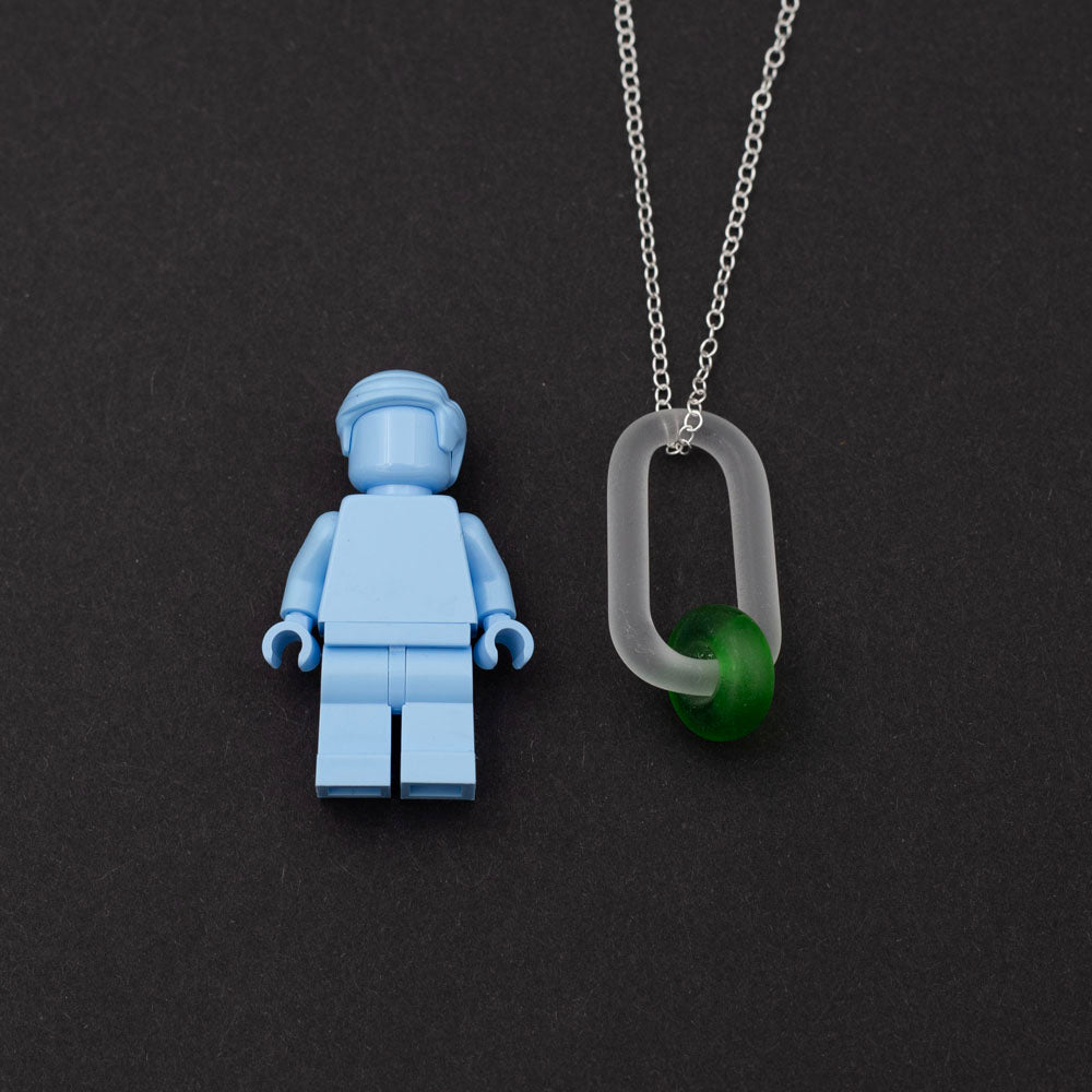 Lego figure with frosted clear glass link and green gin bottle glass bead necklace.