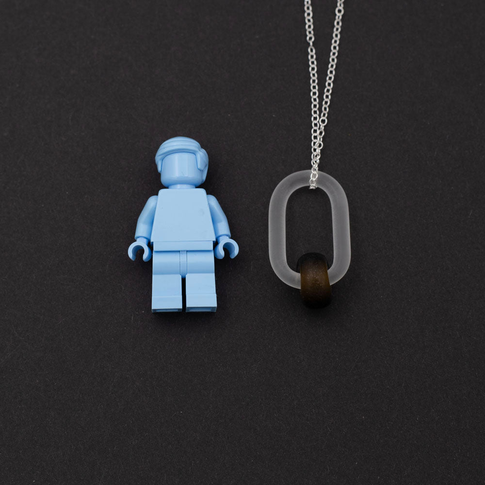 Lego figure with frosted clear glass link and marmite glass bead necklace.