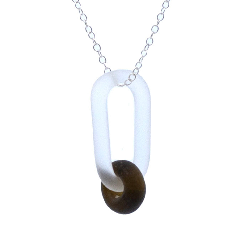 Close up of frosted clear glass link necklace. The link passes through a bead made from recycled brown marmite  bottle glass, and the bead has a frosted finish. The link hangs from a sterling silver chain.