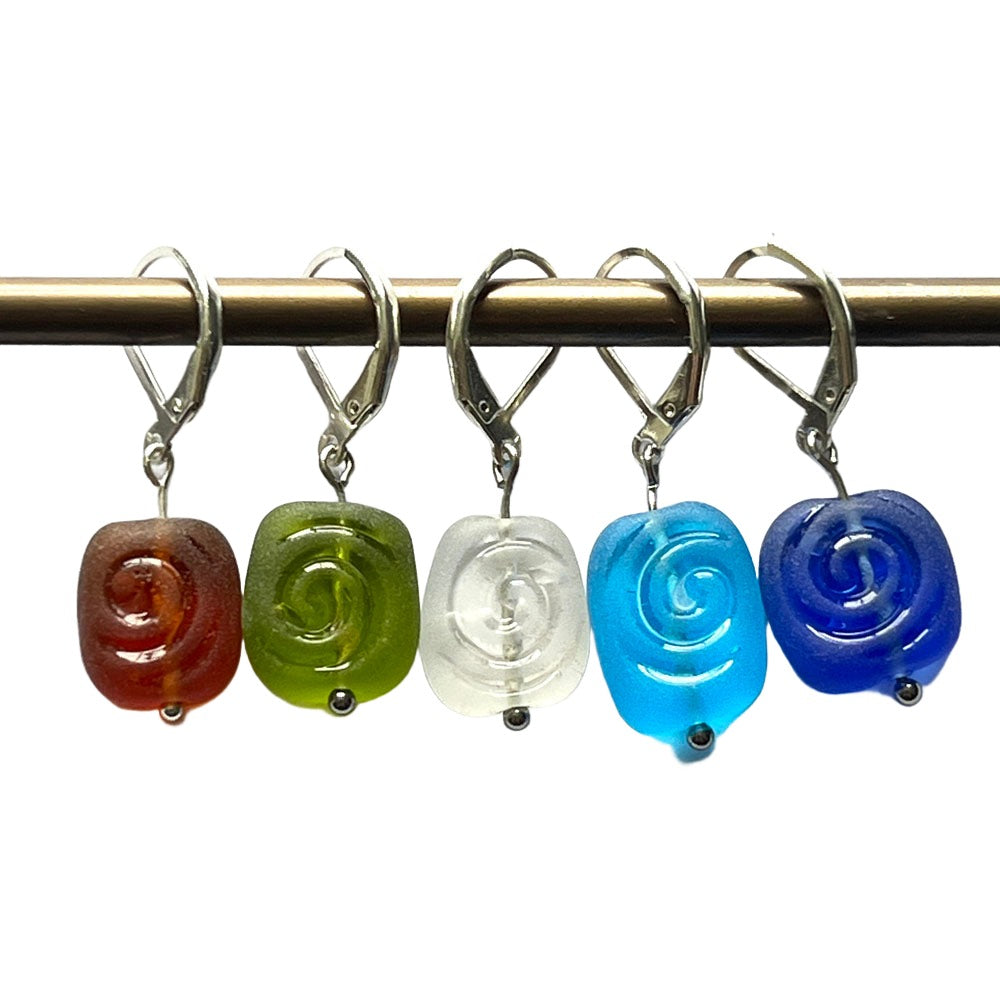 Frosted beads with spiral imprint in amber, green, clear, turquoise and blue glass. The beads hang from latch back hooks to make stitch markers.