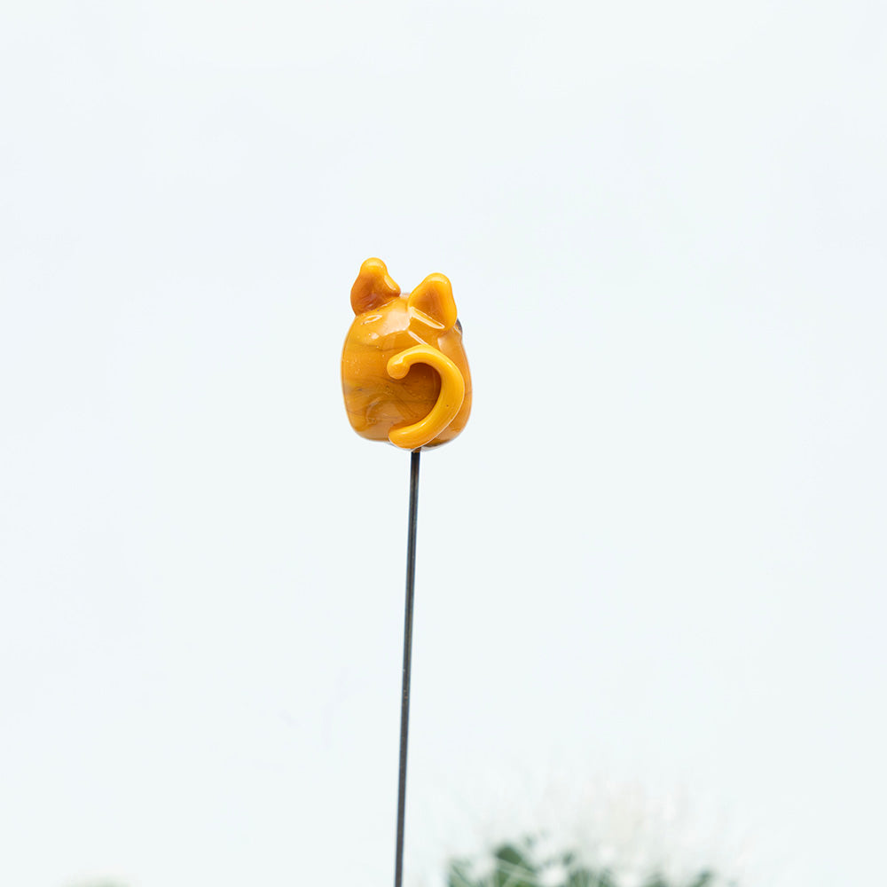 back view  of ginger glass cat.