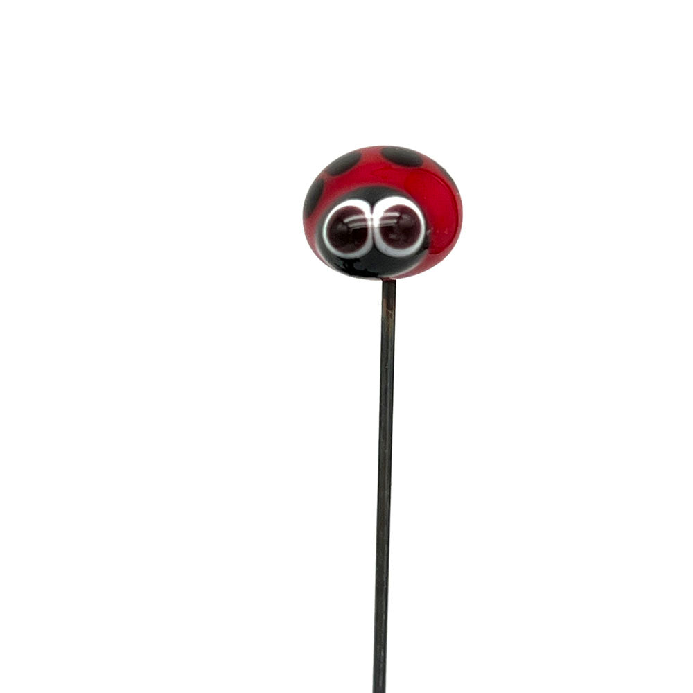 Glass ladybird plant decoration with large eyes on a metal stake, front view, by Joy McMillan Glass