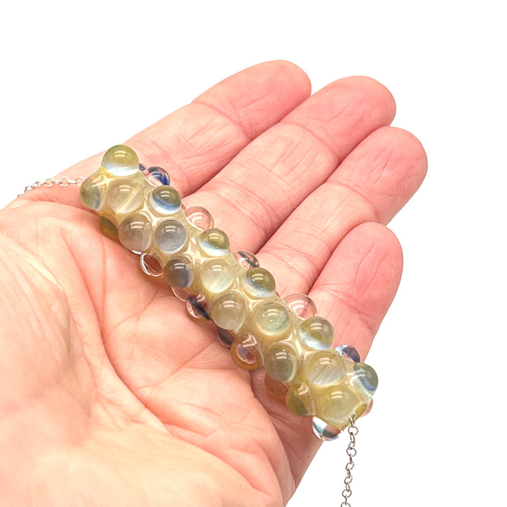 Lemonade bead necklace shown in the palm of a hand. 