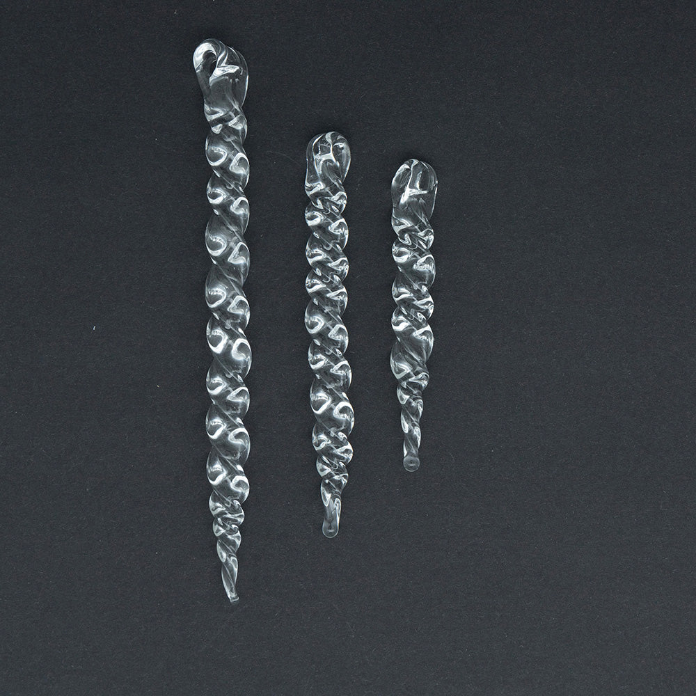 Three glass icicle smade from chunky glass rod. The icicles are three sizes, large, medium and small. The icicles twist along their length and have a hanging loop.