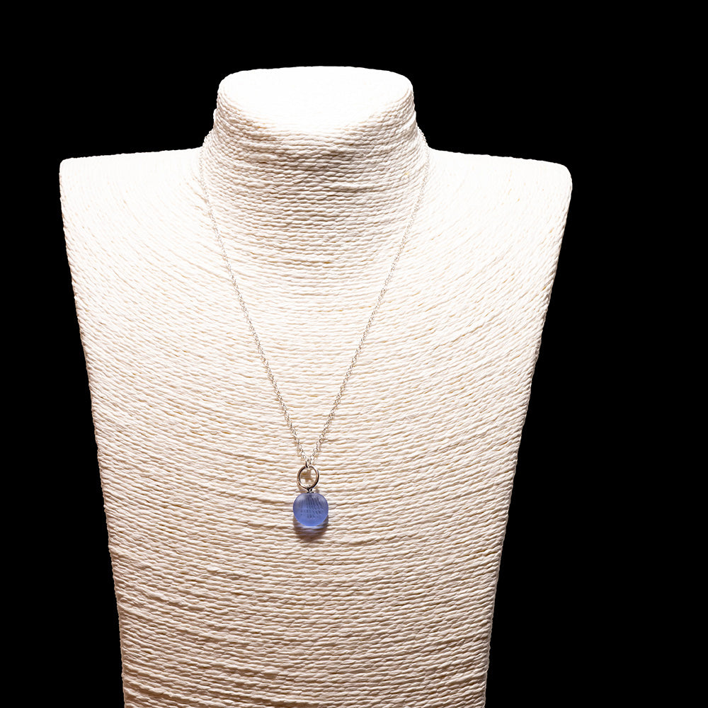 blue frosted glass shell imprint charm necklace with sterling silver chain shown on a white mannequin bust