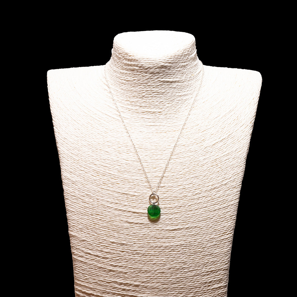 green frosted glass shell imprint charm necklace with sterling silver chain shown on a white mannequin bust