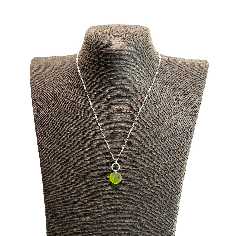 lime green glass shell imprint charm necklace with sterling silver chain shown on a black mannequin bust