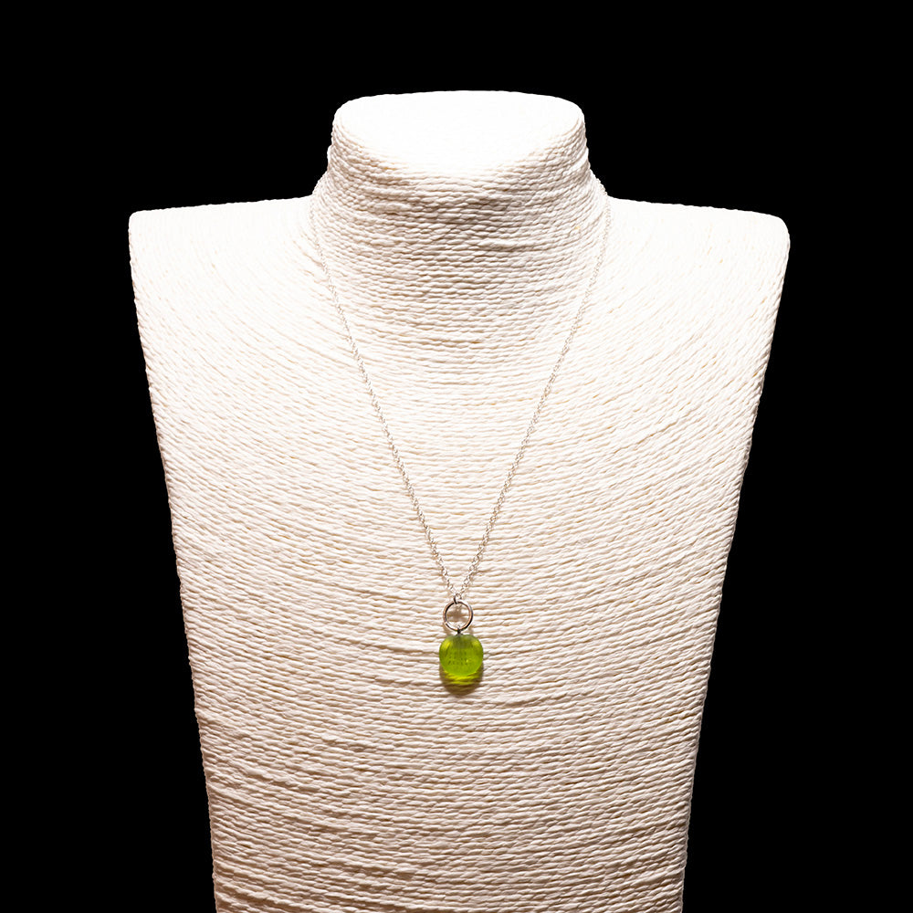 lime green frosted glass shell imprint charm necklace with sterling silver chain shown on a white mannequin bust