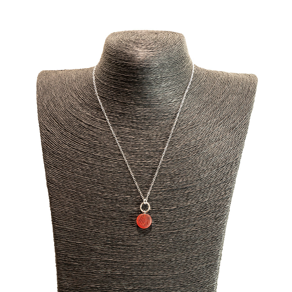 orange glass shell imprint charm necklace with sterling silver chain shown on a black mannequin bust