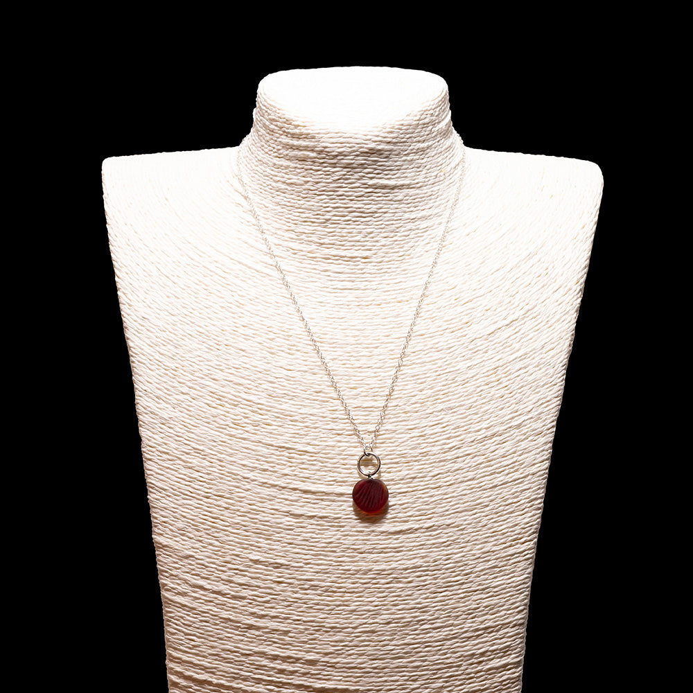 red frosted glass shell imprint charm necklace with sterling silver chain shown on a white mannequin bust