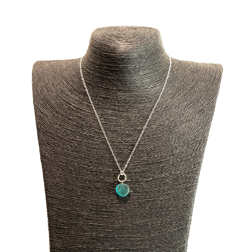 teal glass shell imprint charm necklace with sterling silver chain shown on a black mannequin bust