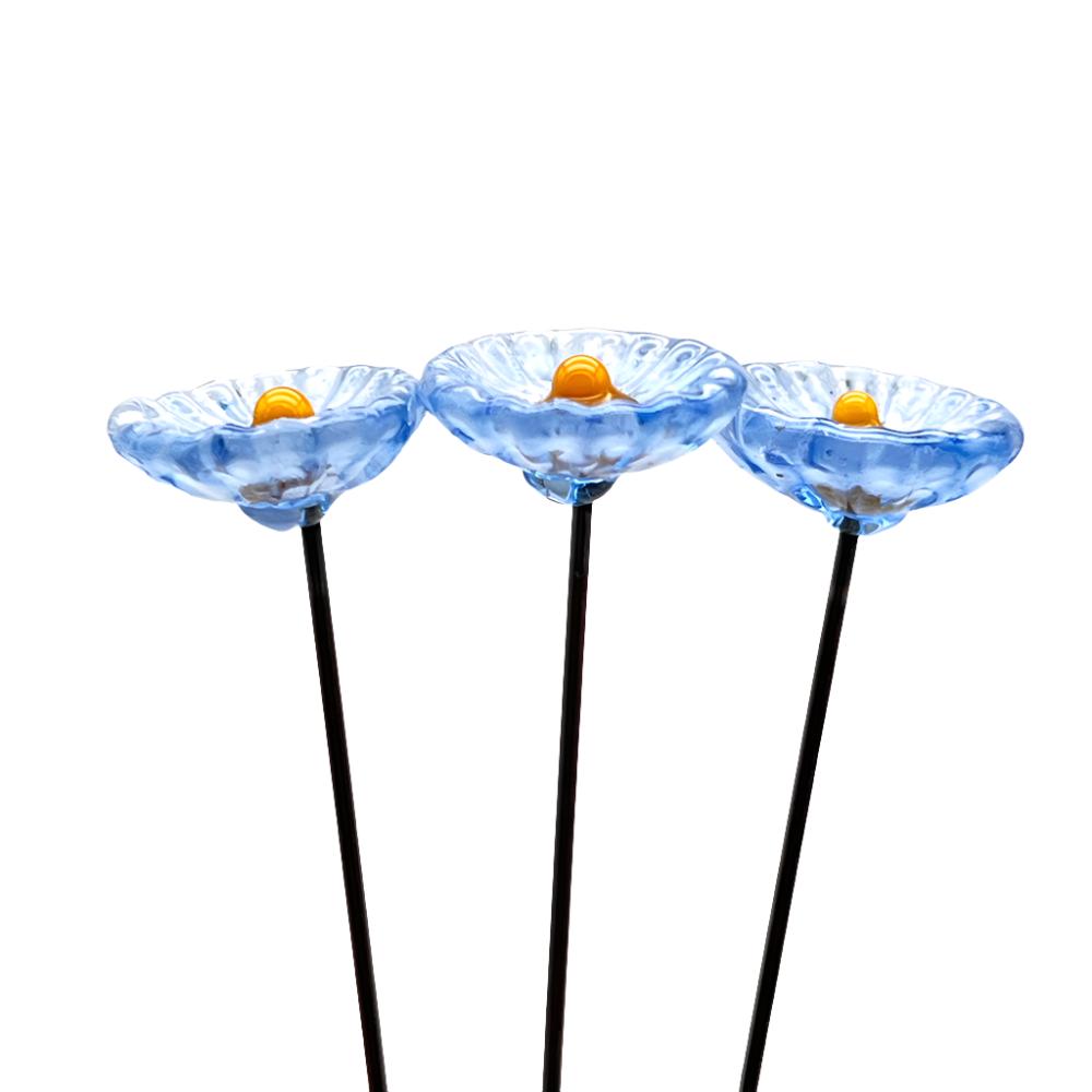 three speckled periwinkle blue glass daisies with yellow centres on metal stakes