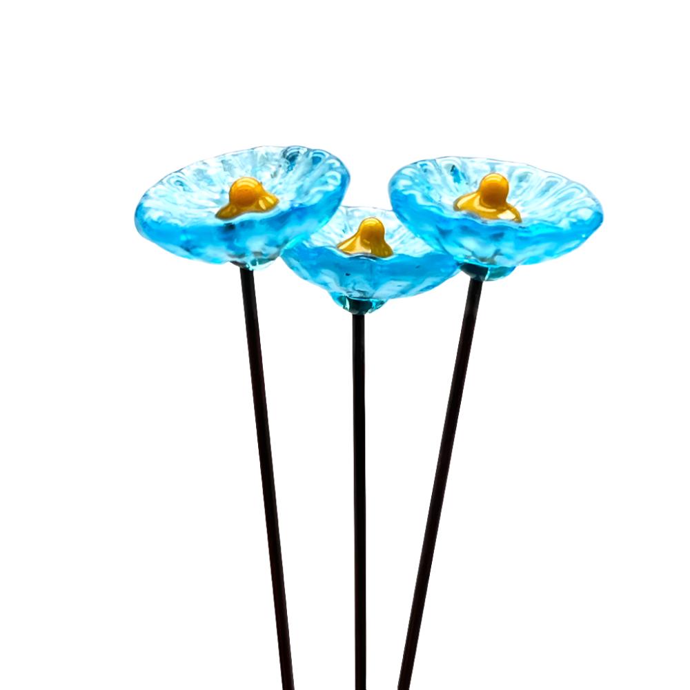 three speckled turquoise glass daisies with yellow centres on metal stakes