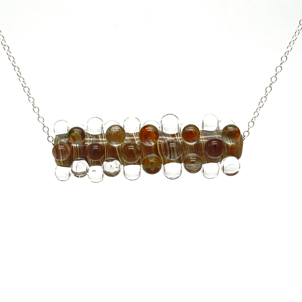 Strata glass bead necklace with sterling liver chain in front of a white background.