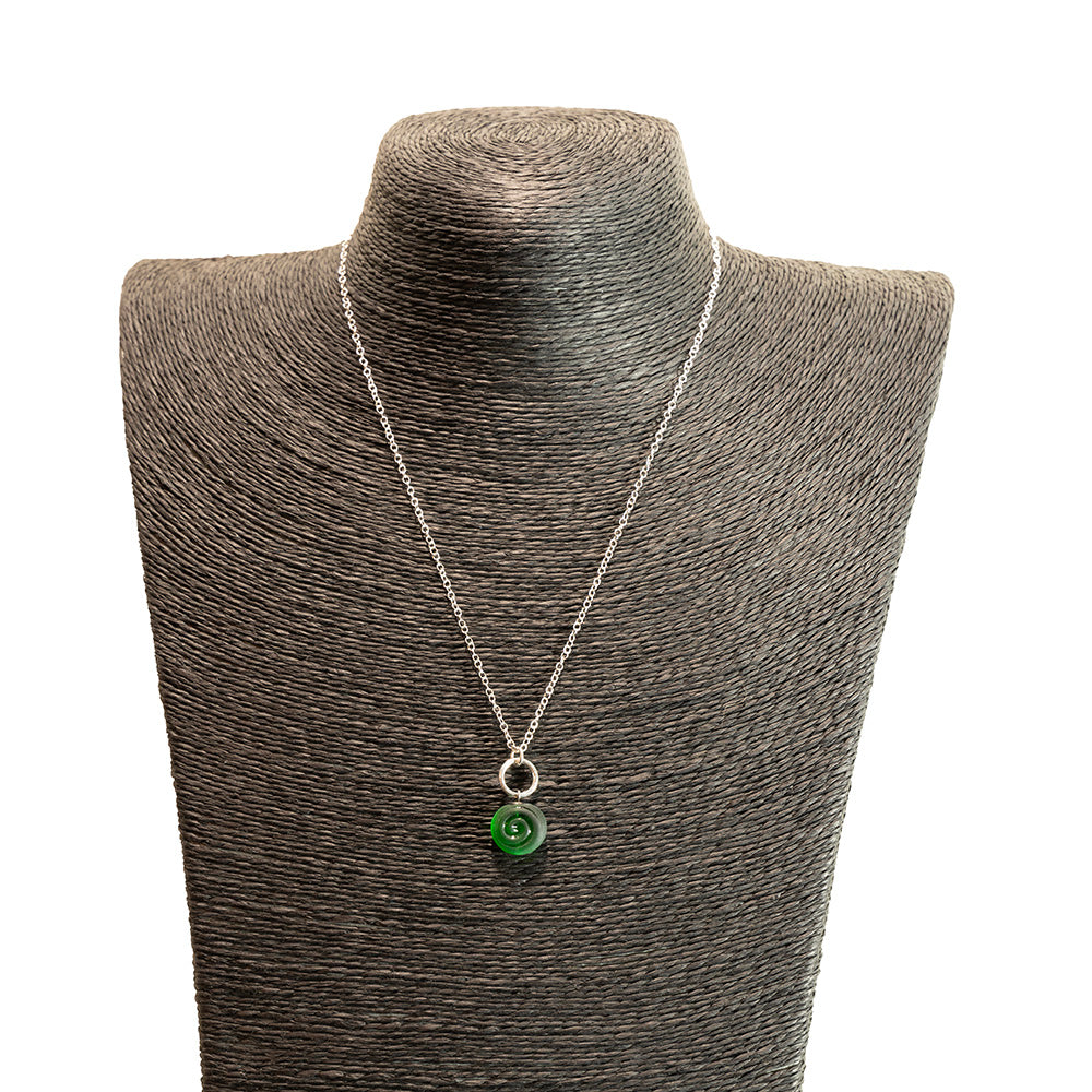 green swirl charm necklace shown on a black mannequin bust