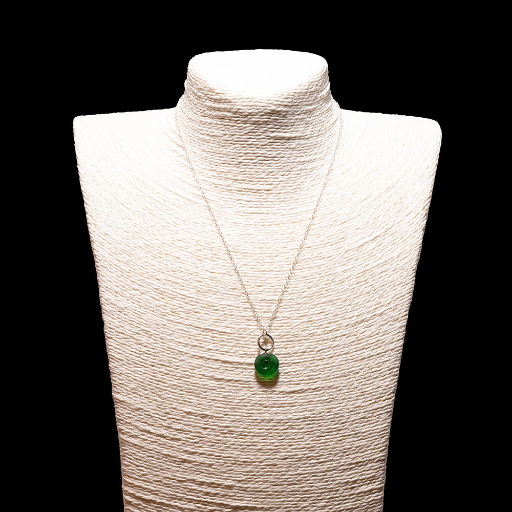 green glass swirl charm necklace with sterling silver chain shown on a white mannequin bust