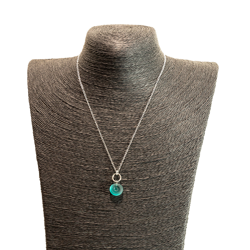 teal swirl charm necklace shown on a black mannequin bust